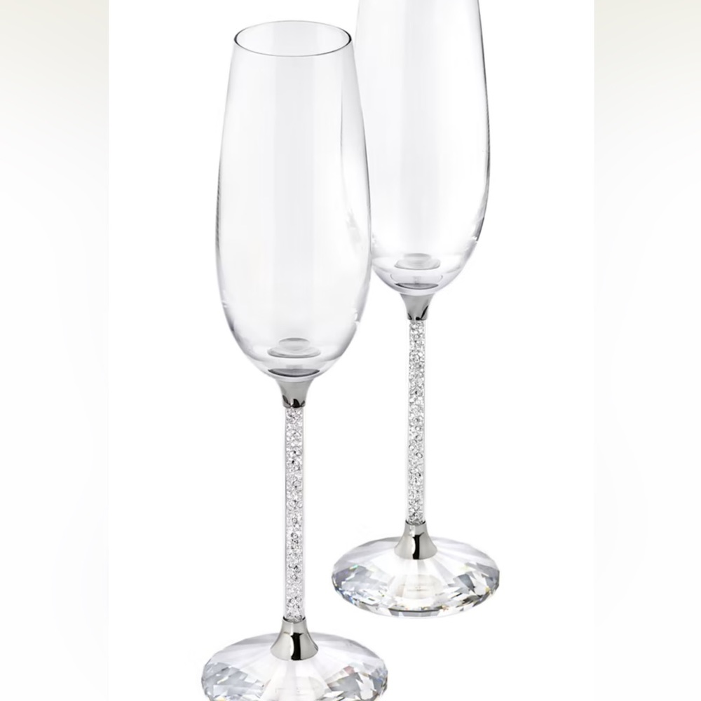 Like new. Never used. Beautiful Swarovski crystalline champagne flute set.